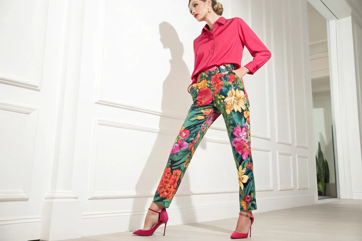 Bold floral trousers paired with a chic pink blouse