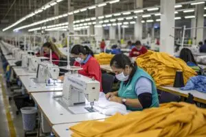 a-factory-floor-with-workers-operating-sewing-mac