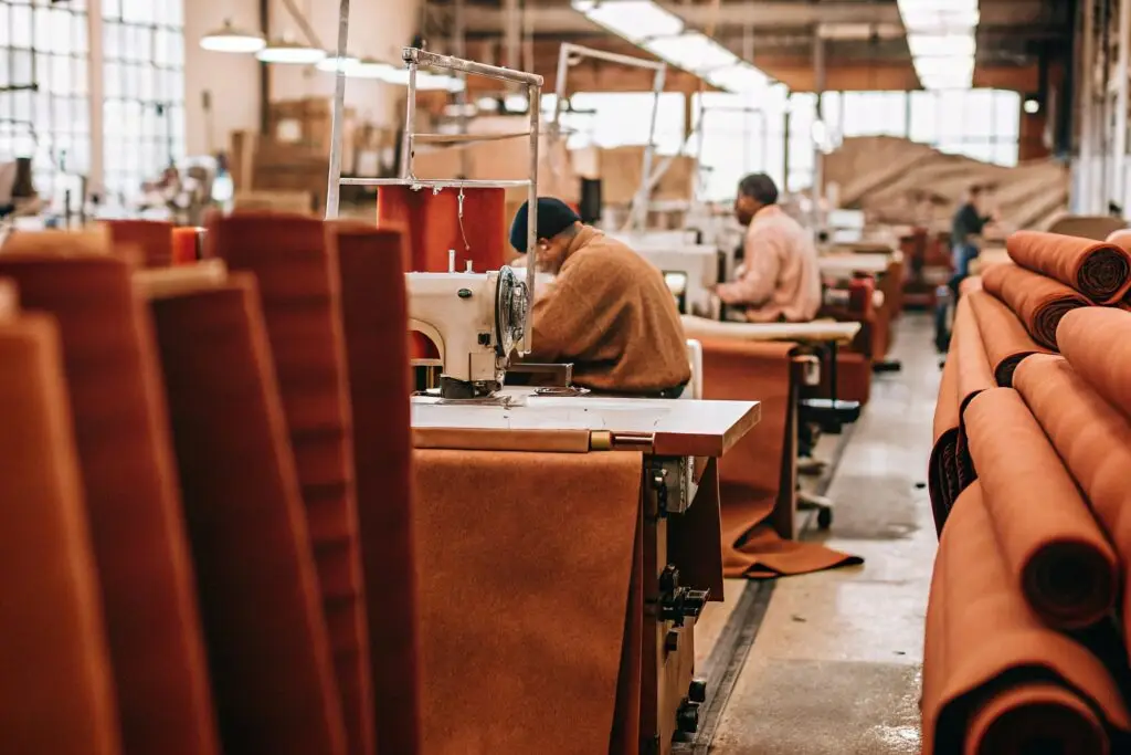 Clothing factory with skilled workers sewing garments using industrial machines