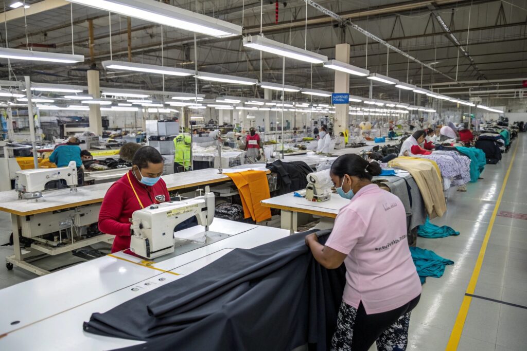 Modern clothing factory with workers engaged in garment production