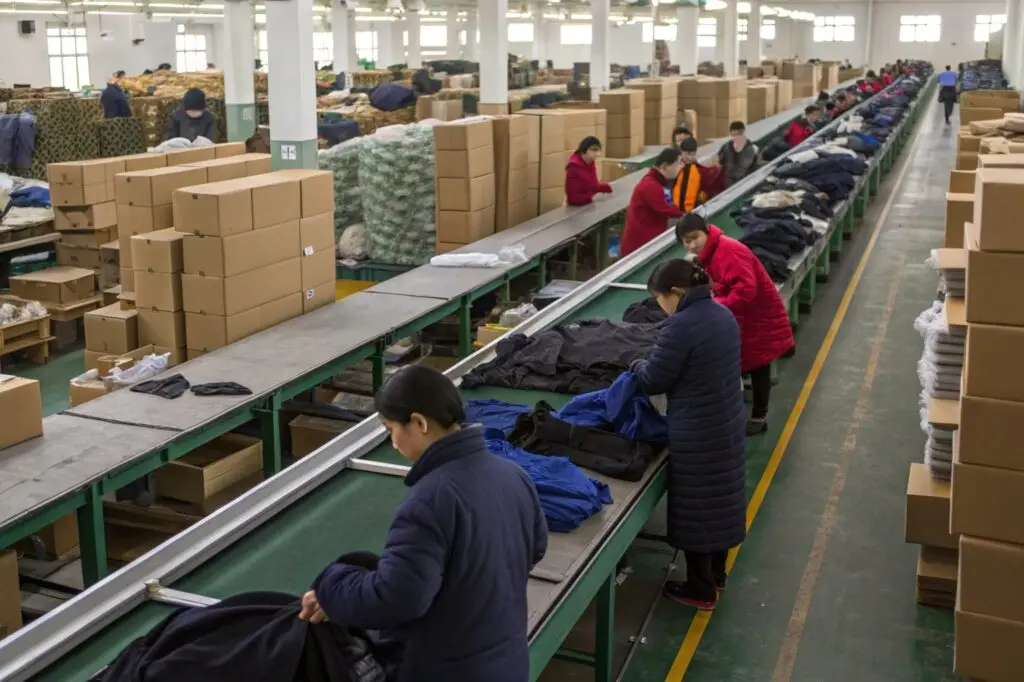 Workers sorting and packaging garments in a clothing factory