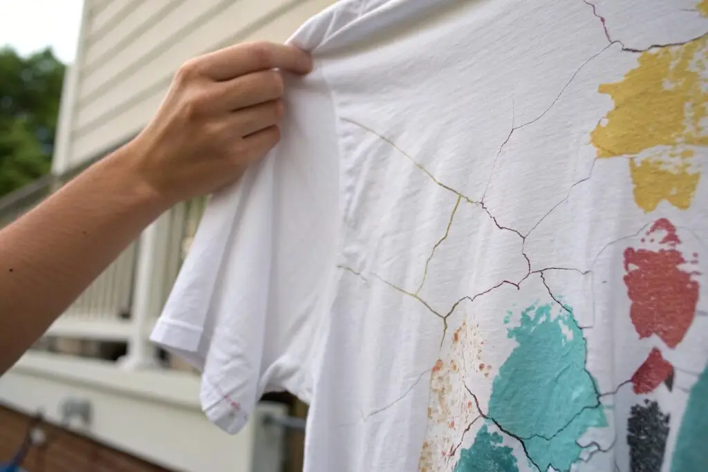 Close-up of a hand-painted t-shirt with cracked paint