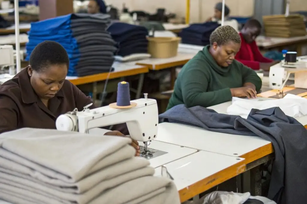 Tailors sewing garments in small workshop