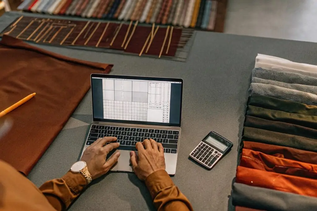 A fashion entrepreneur working on digital pattern design for apparel production.