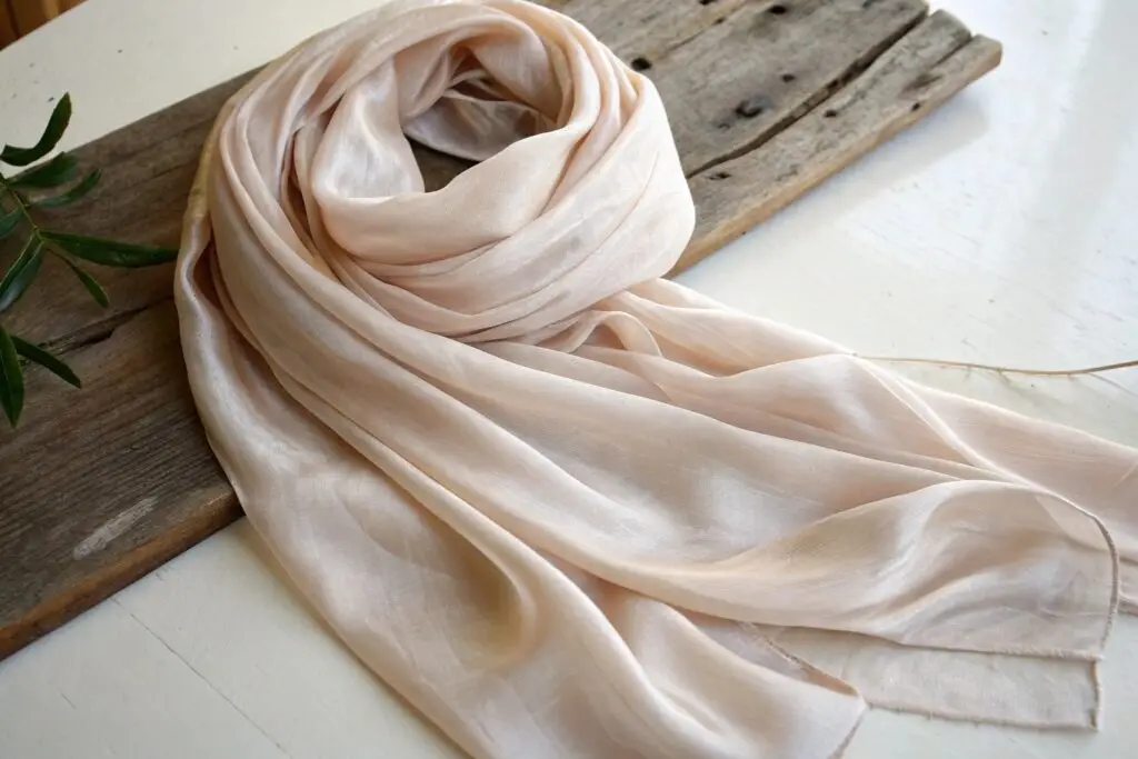 Women's soft silk scarf in blush pink, lightweight and elegant