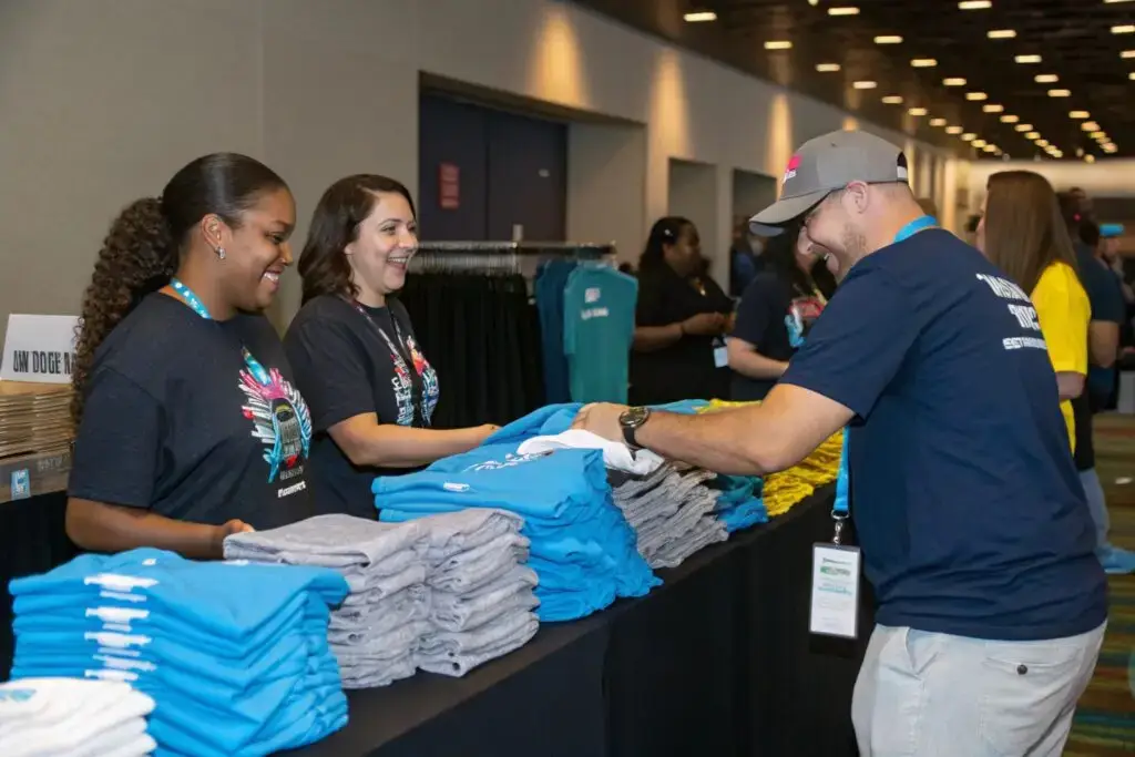 Event staff distributing custom t-shirts