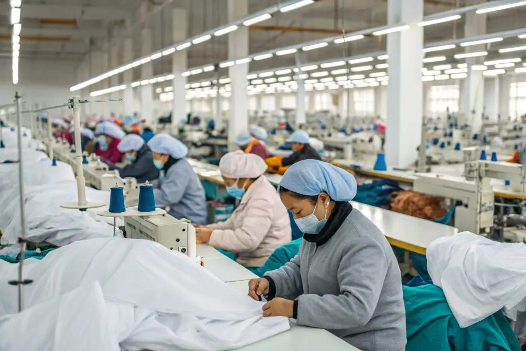 A high-capacity garment production factory in China with workers sewing clothes