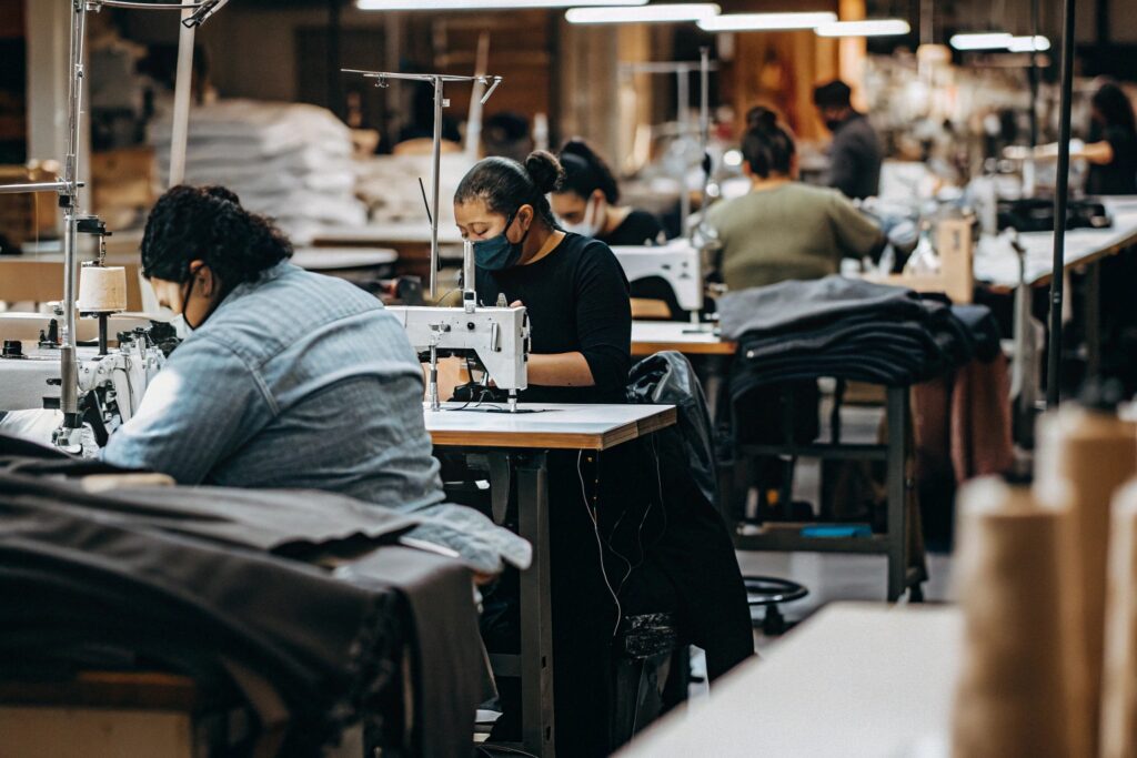 Workers sewing garments in a modern factory