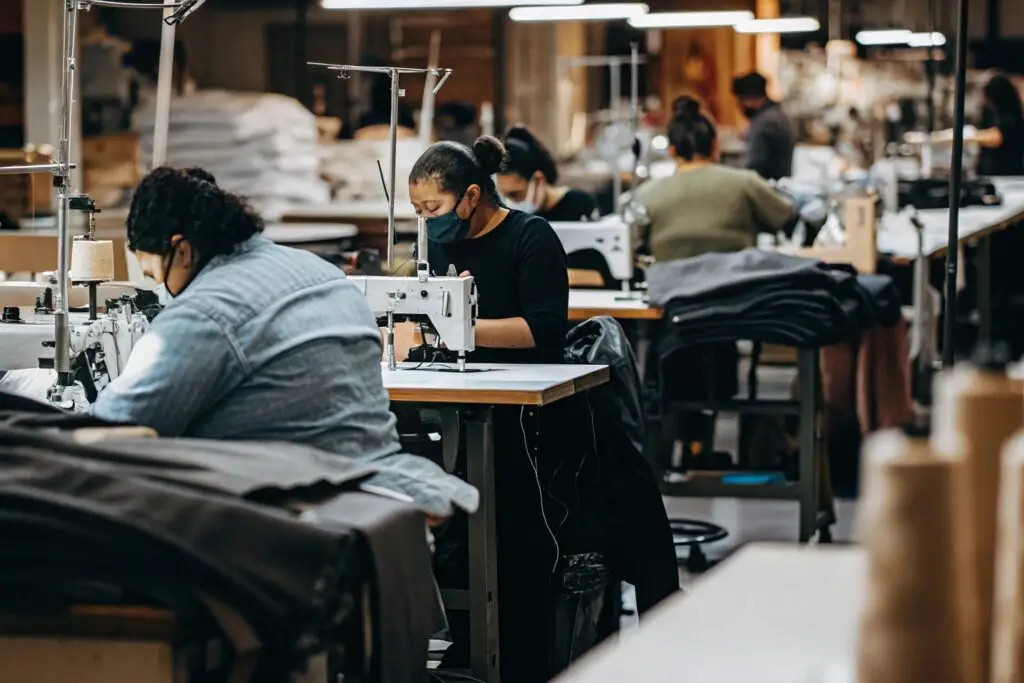 Workers sewing garments in a modern factory