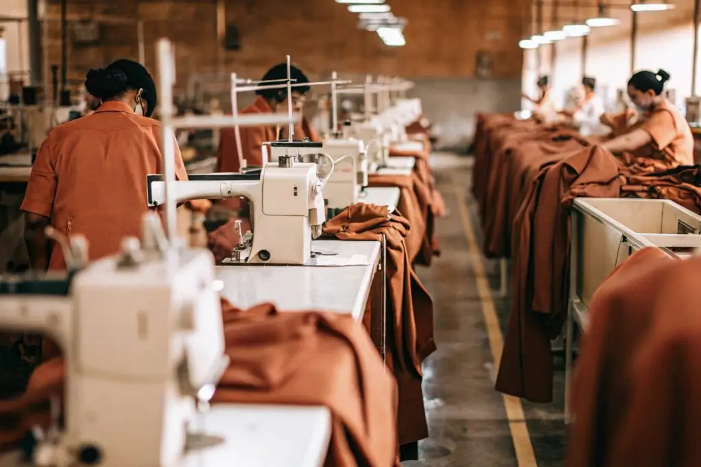 Modern clothing manufacturing facility with skilled workers and sewing machines