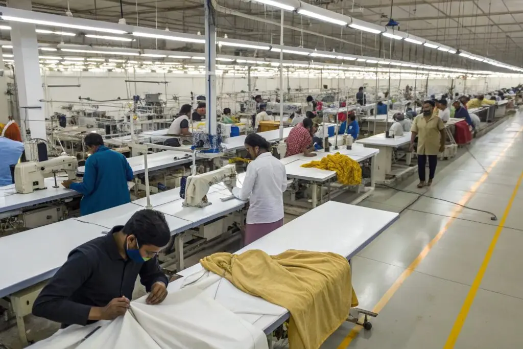 Workers sewing garments in a modern textile factory