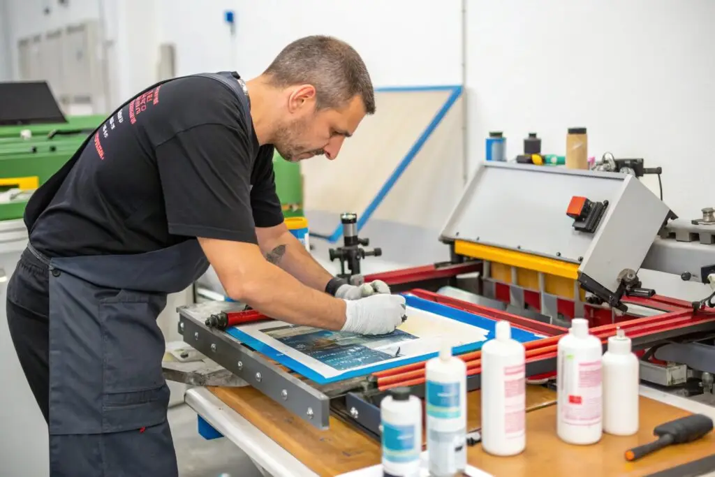 Professional technician performing screen printing maintenance