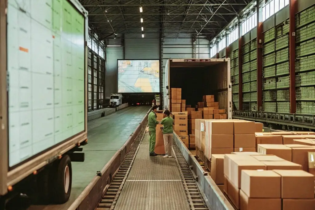 A well-organized logistics hub where workers pack and load apparel shipments into a truck, ensuring efficient global distribution.