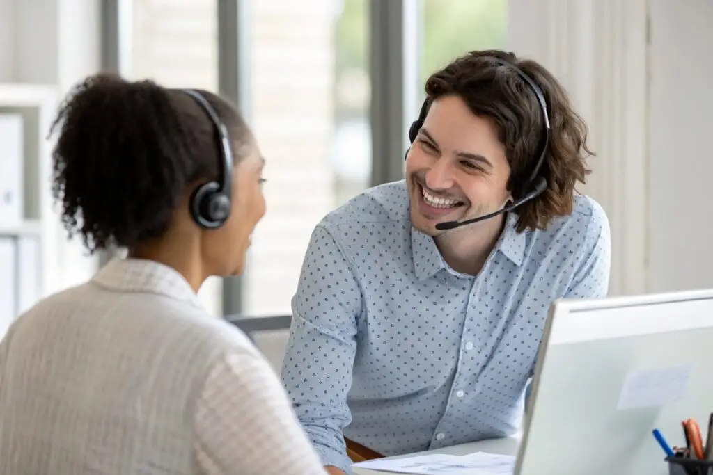 Customer service representatives wearing headsets, providing support