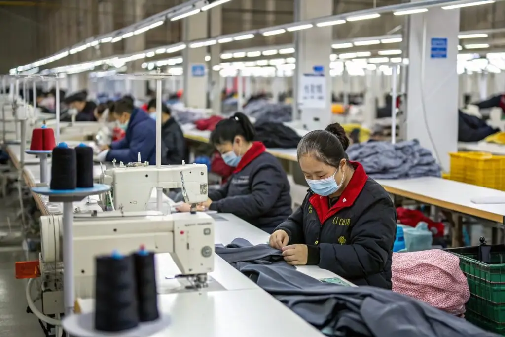 Modern clothing factory in China with skilled workers sewing garments