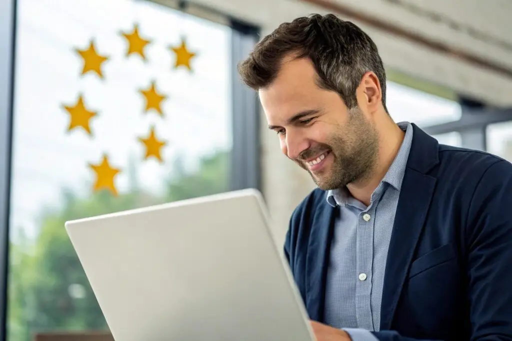 Business owner reading positive customer reviews on a laptop