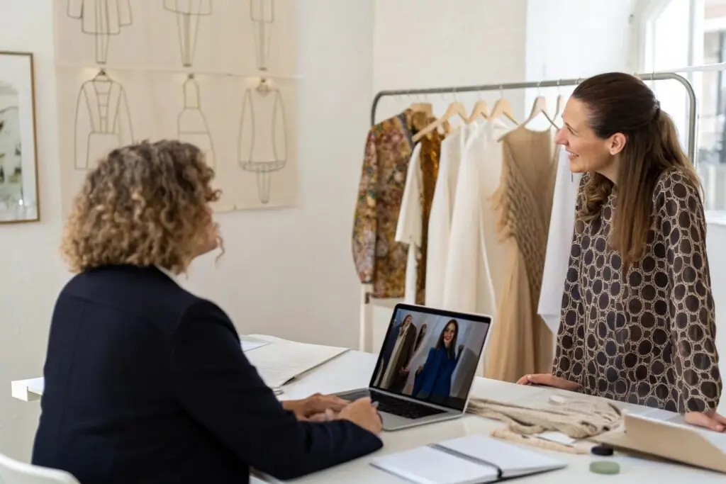 Fashion boutique owner discussing designs with a business partner