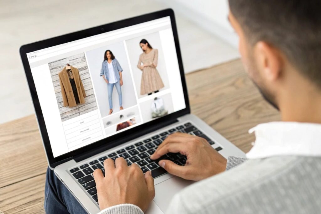 Man browsing an online fashion store on a laptop
