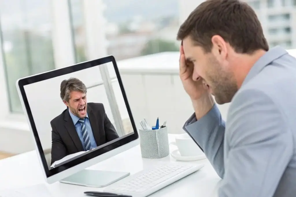 Businessman frustrated with a video call conversation