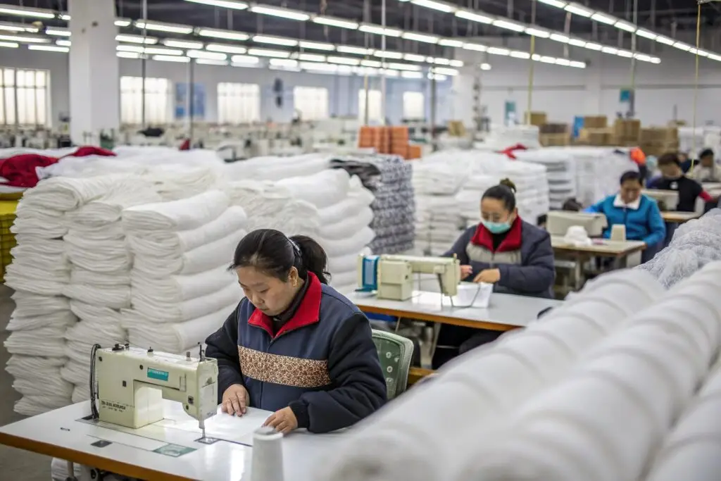 Workers sewing garments in a textile manufacturing factory