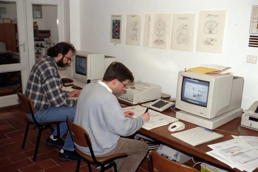 Vintage office with retro computers and professionals working on technical drawings