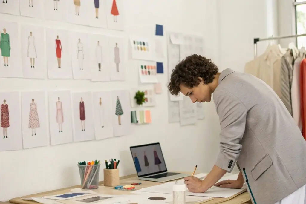 Fashion designer sketching new clothing concepts in a creative workspace