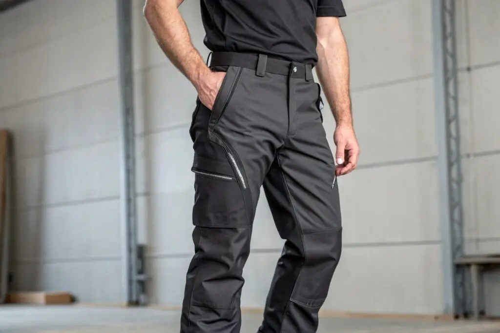 Men's black work pants with zippered pockets, durable and functional design