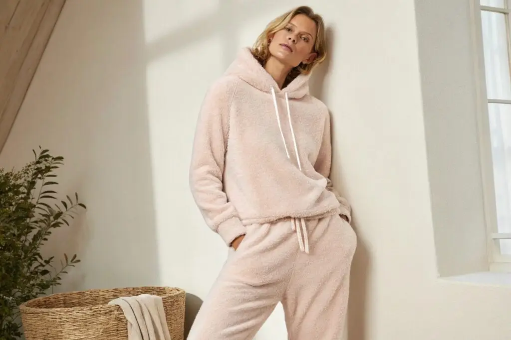 Woman wearing a pink cotton fleece hoodie and sweatpants