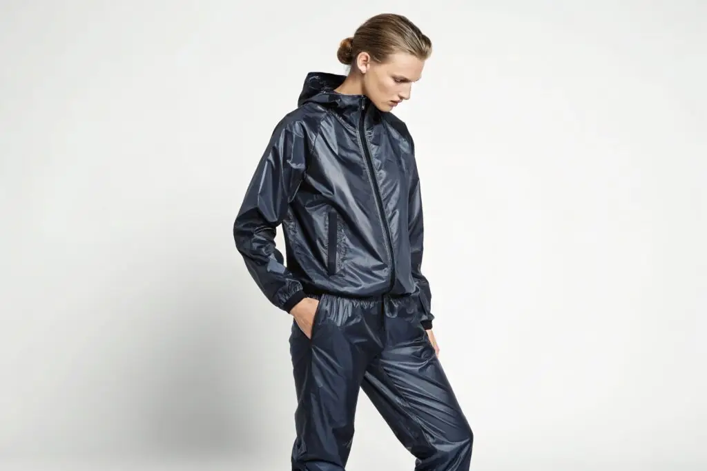 Woman wearing a sleek navy nylon tracksuit