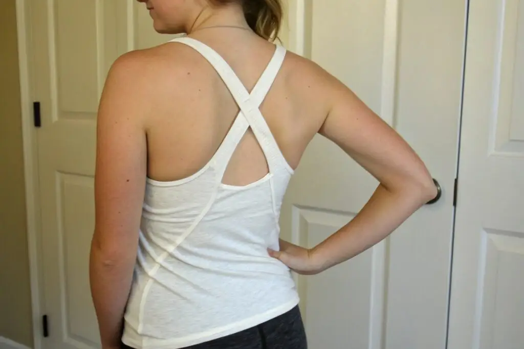 Woman in white racerback tank top