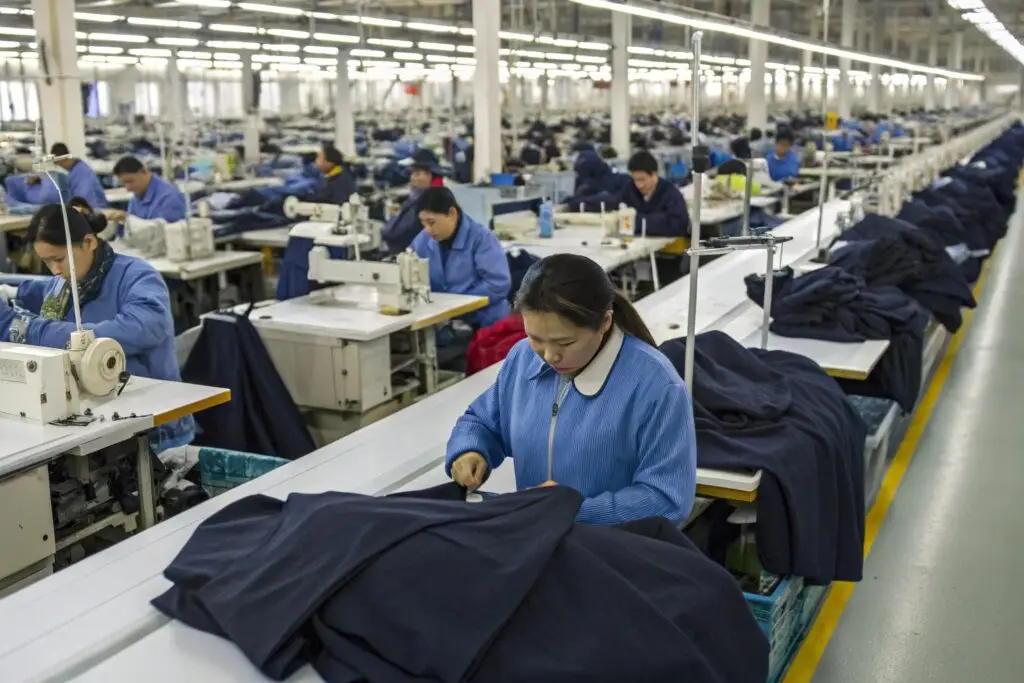 A busy garment factory in China with workers assembling clothing