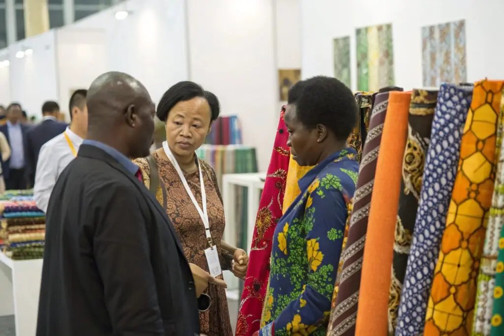 Buyers discussing fabric selection at trade fair