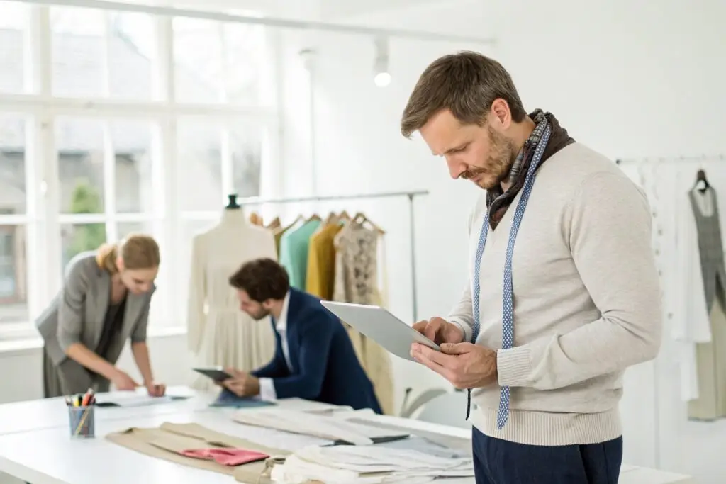 European clothing designer working with team