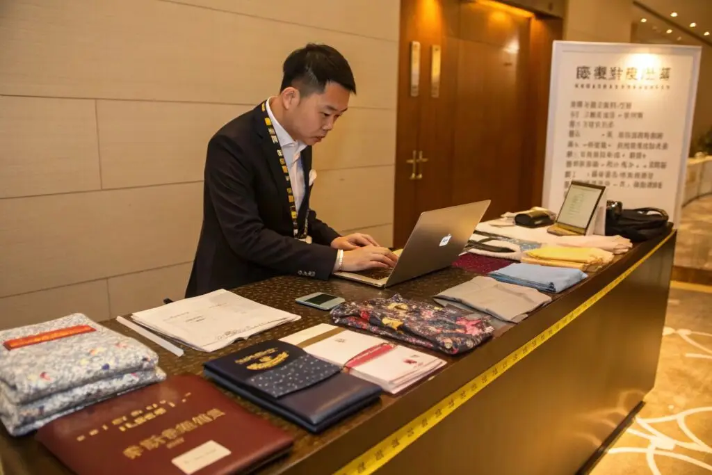 Fashion buyer organizing fabric samples and documents at hotel desk
