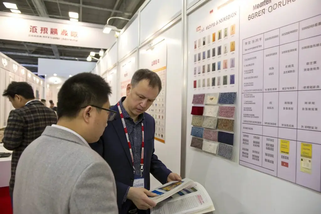 Buyer reviewing fabric samples and discussing order details