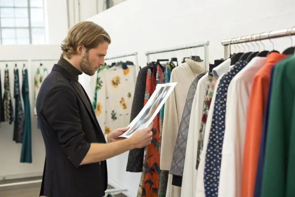 Designer comparing clothing samples with printed designs