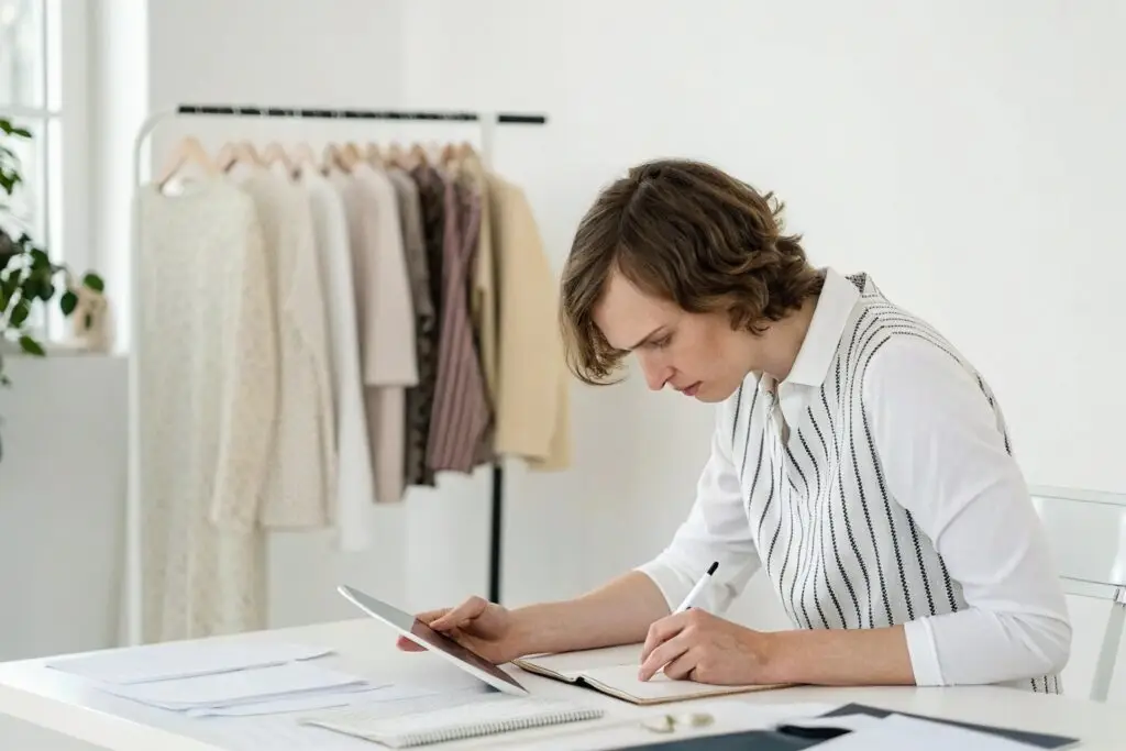 Fashion buyer reviewing documents and sketching ideas