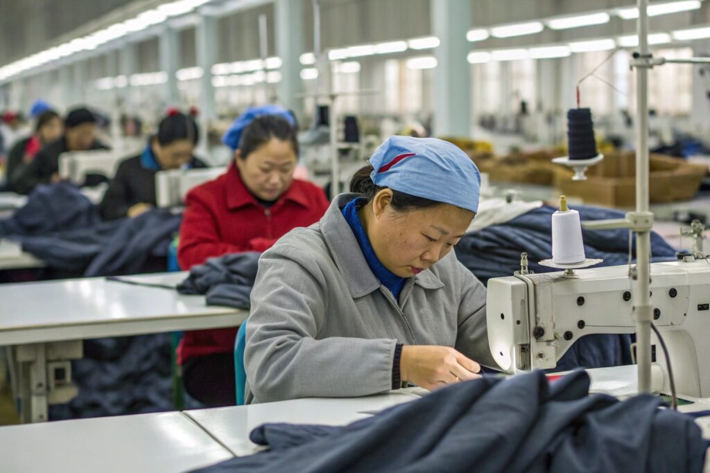 Workers sewing garments in Fumao clothing production line