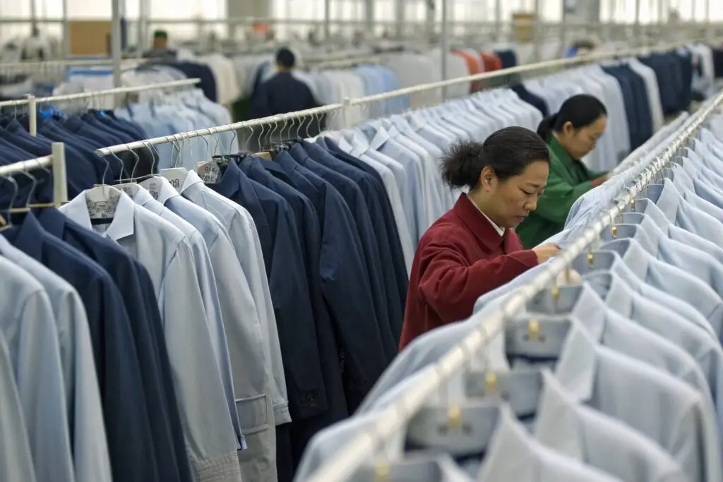 Workers inspecting shirts in a Chinese garment factory