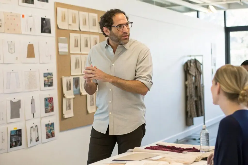 Design meeting with fashion sketches and fabrics