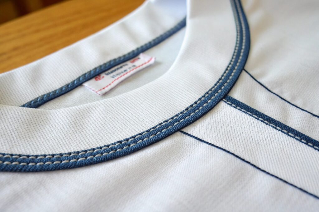 close-up of reinforced neckline with contrast topstitching