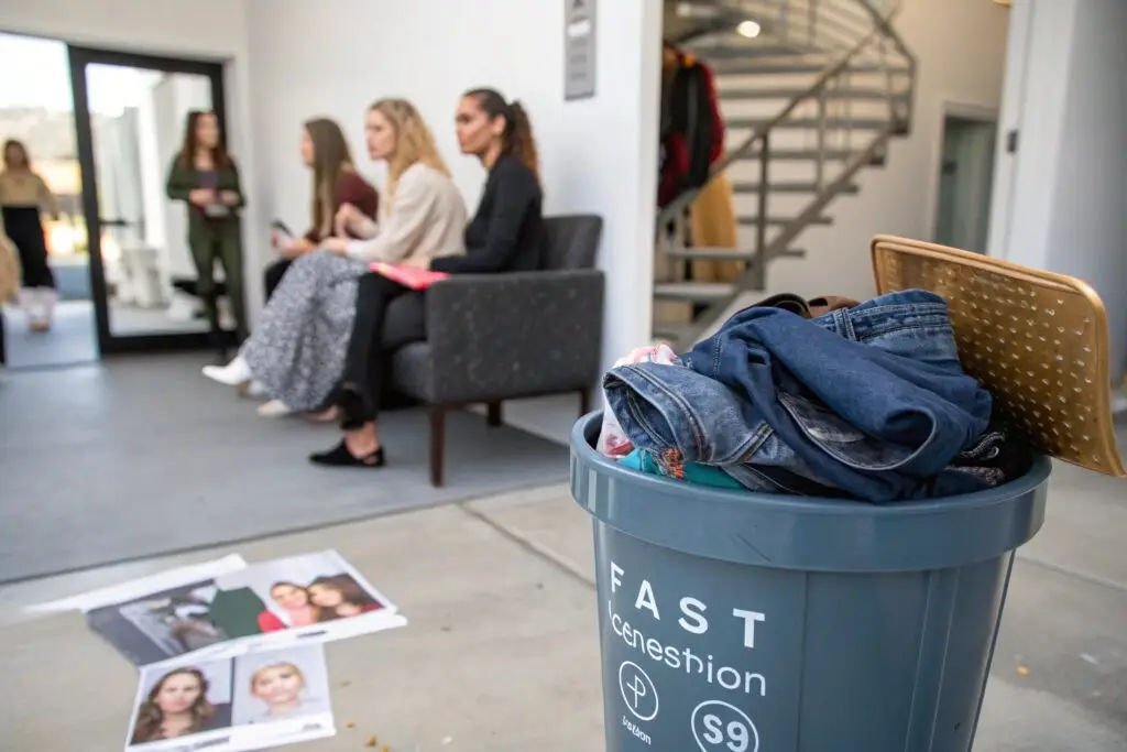 Discarded clothing in bin symbolizing fast fashion waste